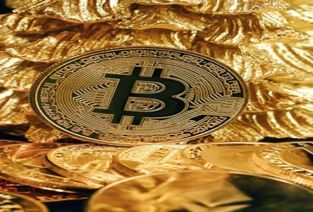 Bitcoin sitting on top of a pile of gold bitcoin